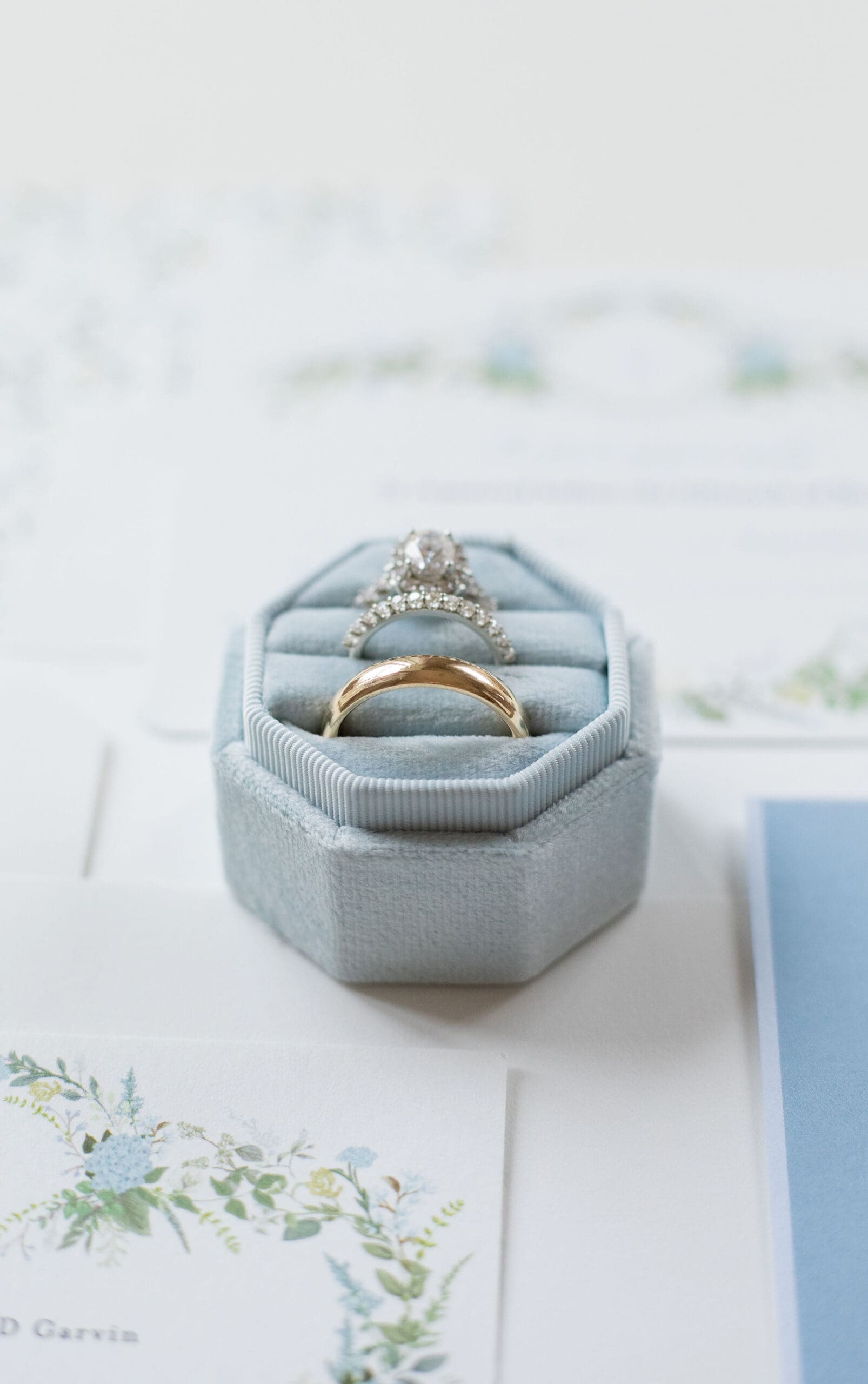 Catholic bride's wedding bands on her Catholic wedding day. Set in a blue ring box for detail photos  