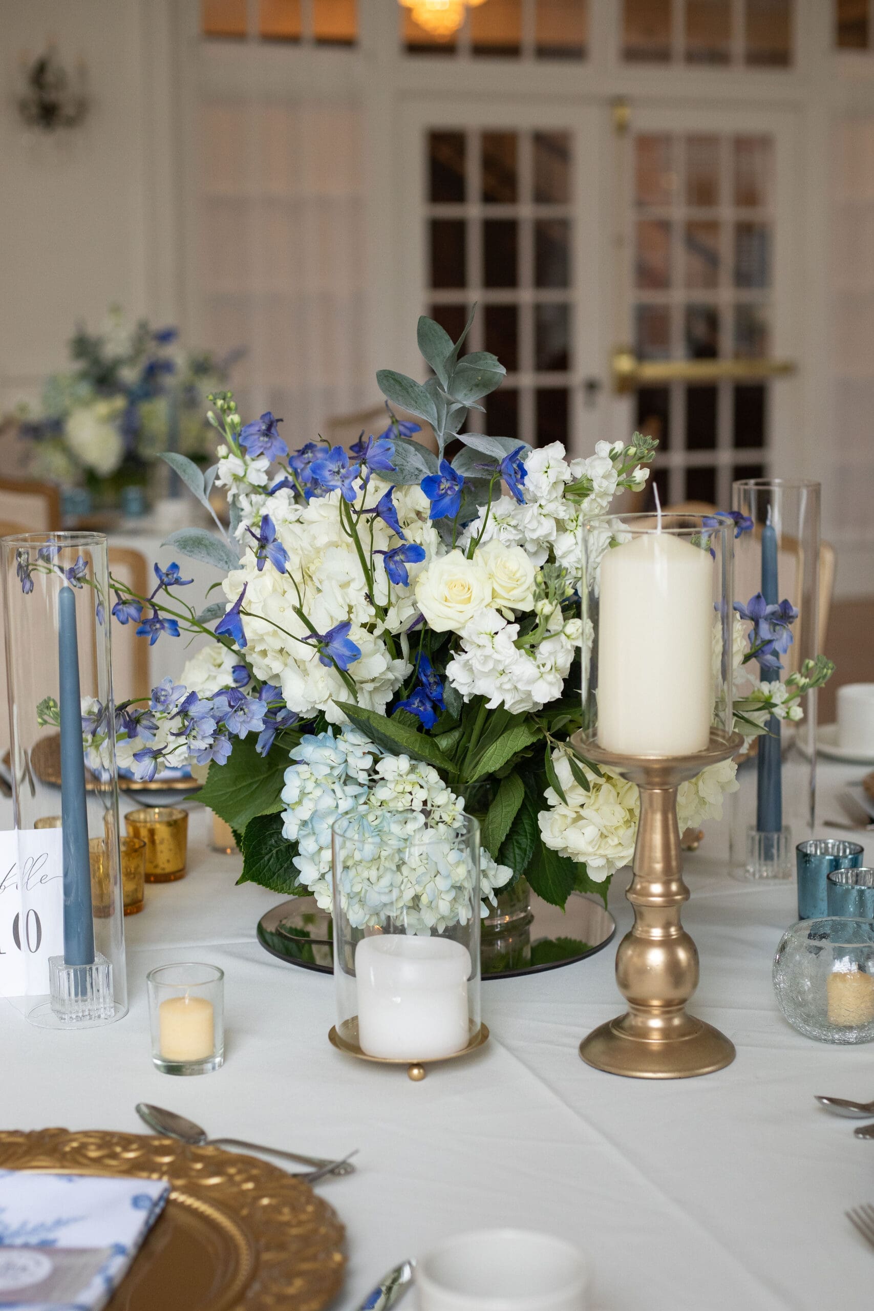 Beautiful hydrangea center piece for a spring wedding set in the Easter season of the Catholic Church. Featuring candles and ornate bouquet 