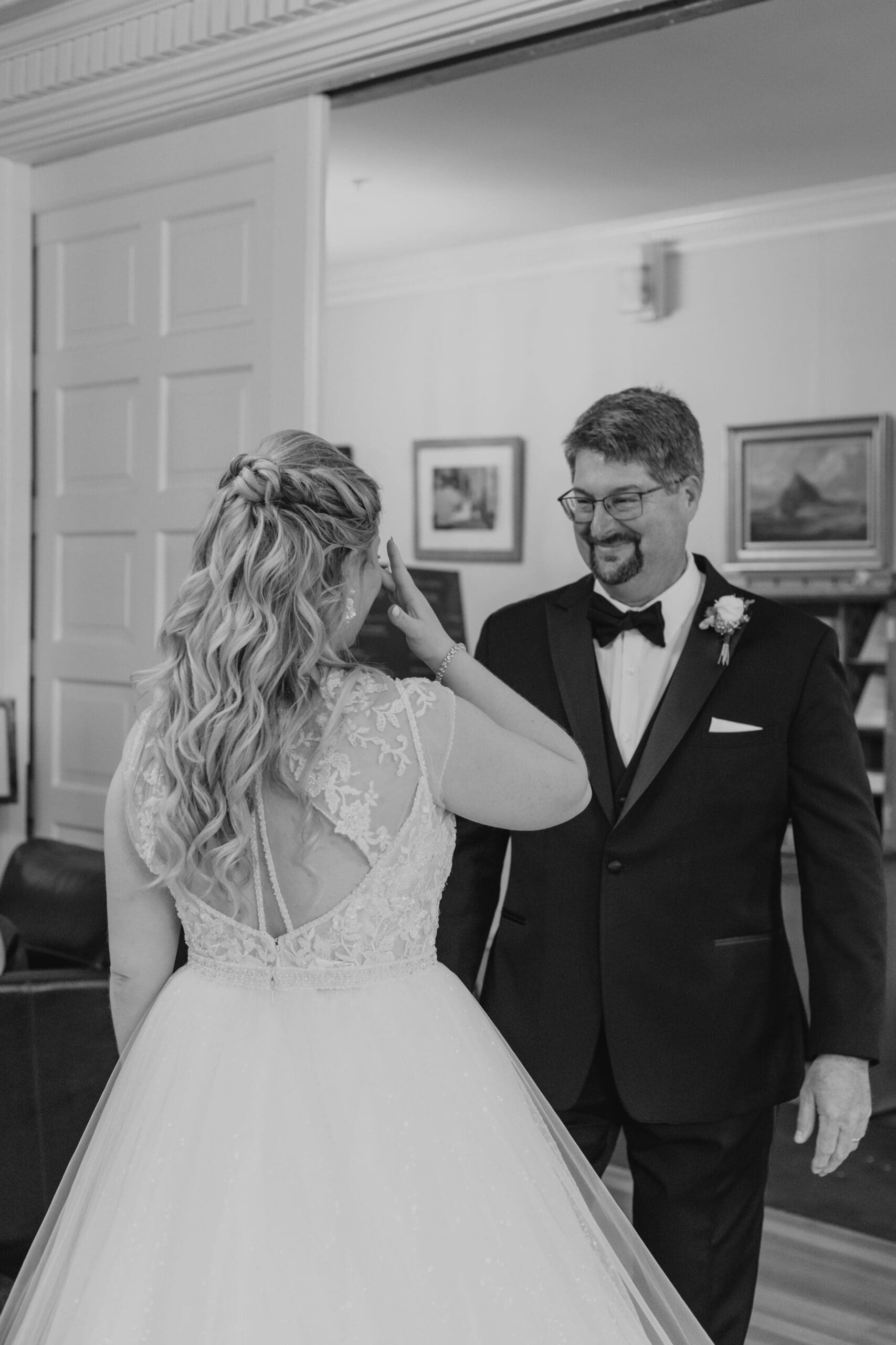Bride gets teary during first look with Father of the bride before Traditional Latin Mass wedding ceremony 