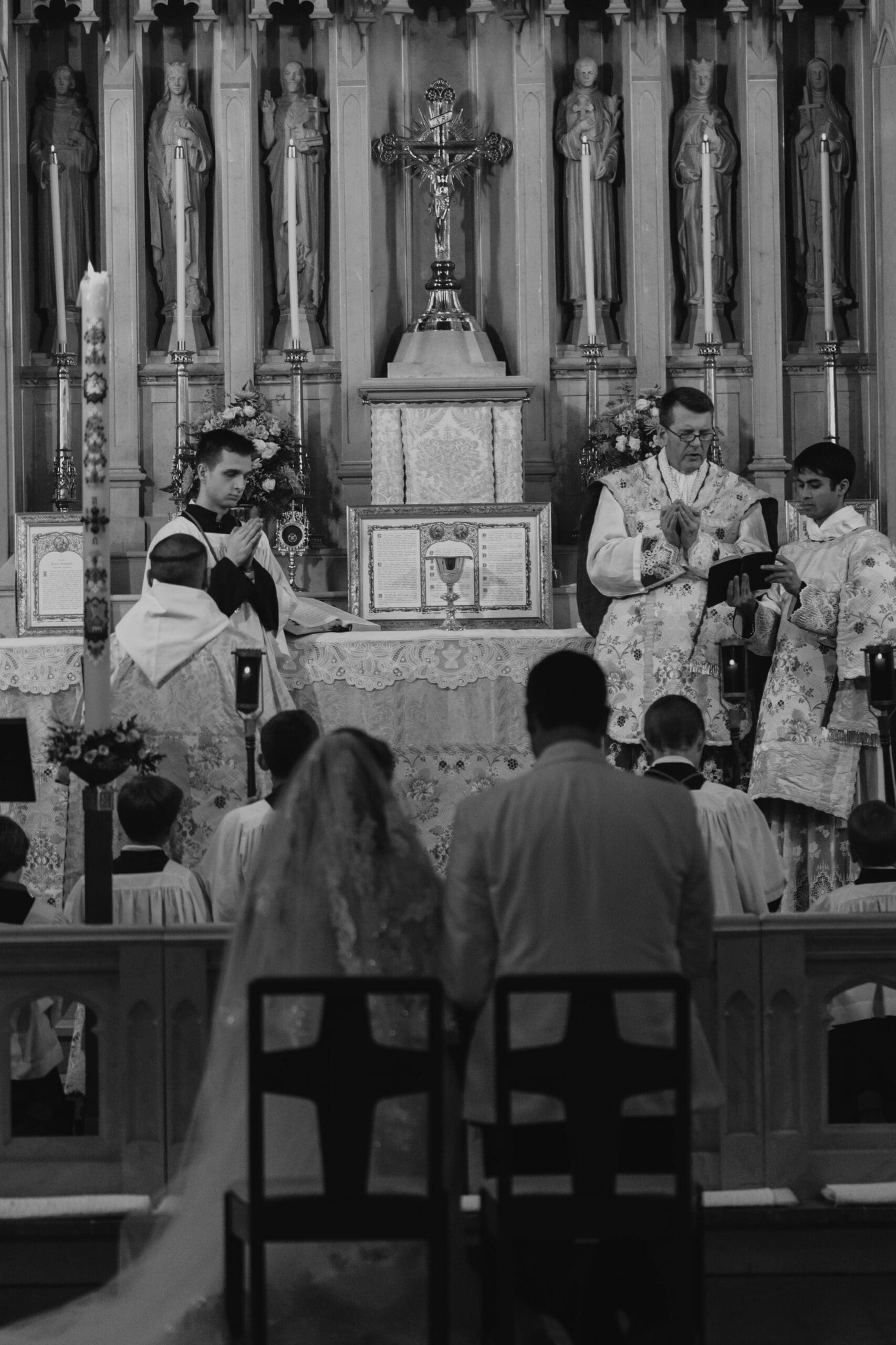 Traditional Latin Mass wedding ceremony featuring the priest reading prayers during the Mass 