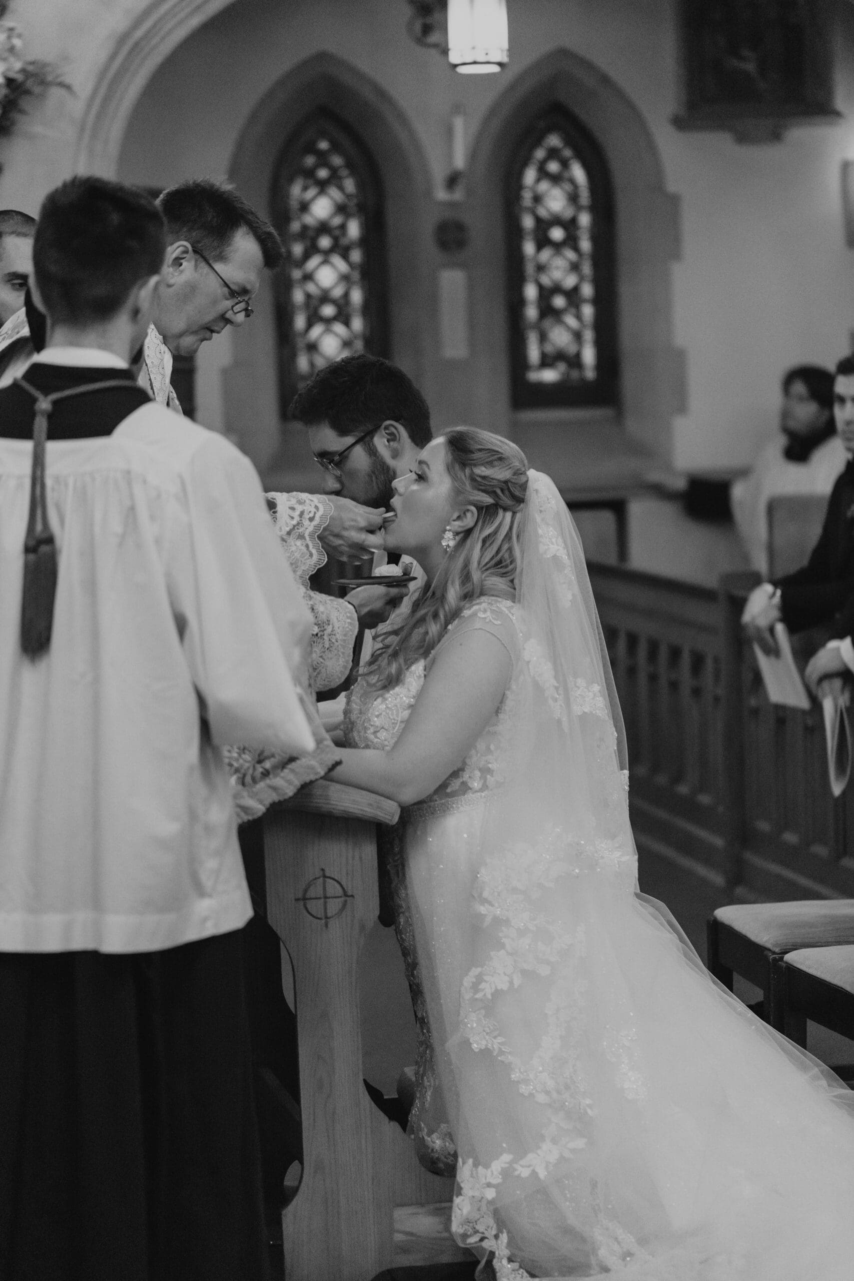 Traditional Latin Mass Wedding ceremony featuring the bride taking communion during her wedding Mass 