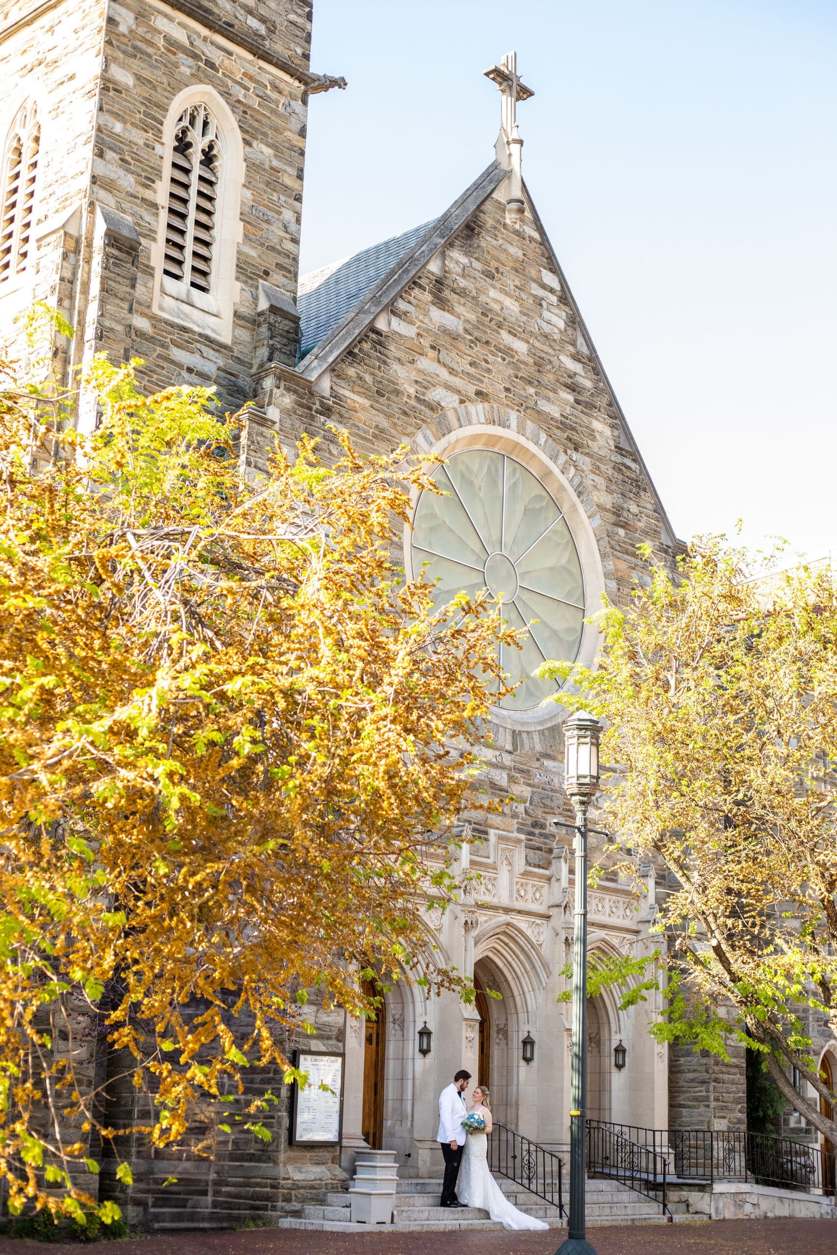 Bride and groom portrait outside of their traditional Latin Rite Catholic Church 