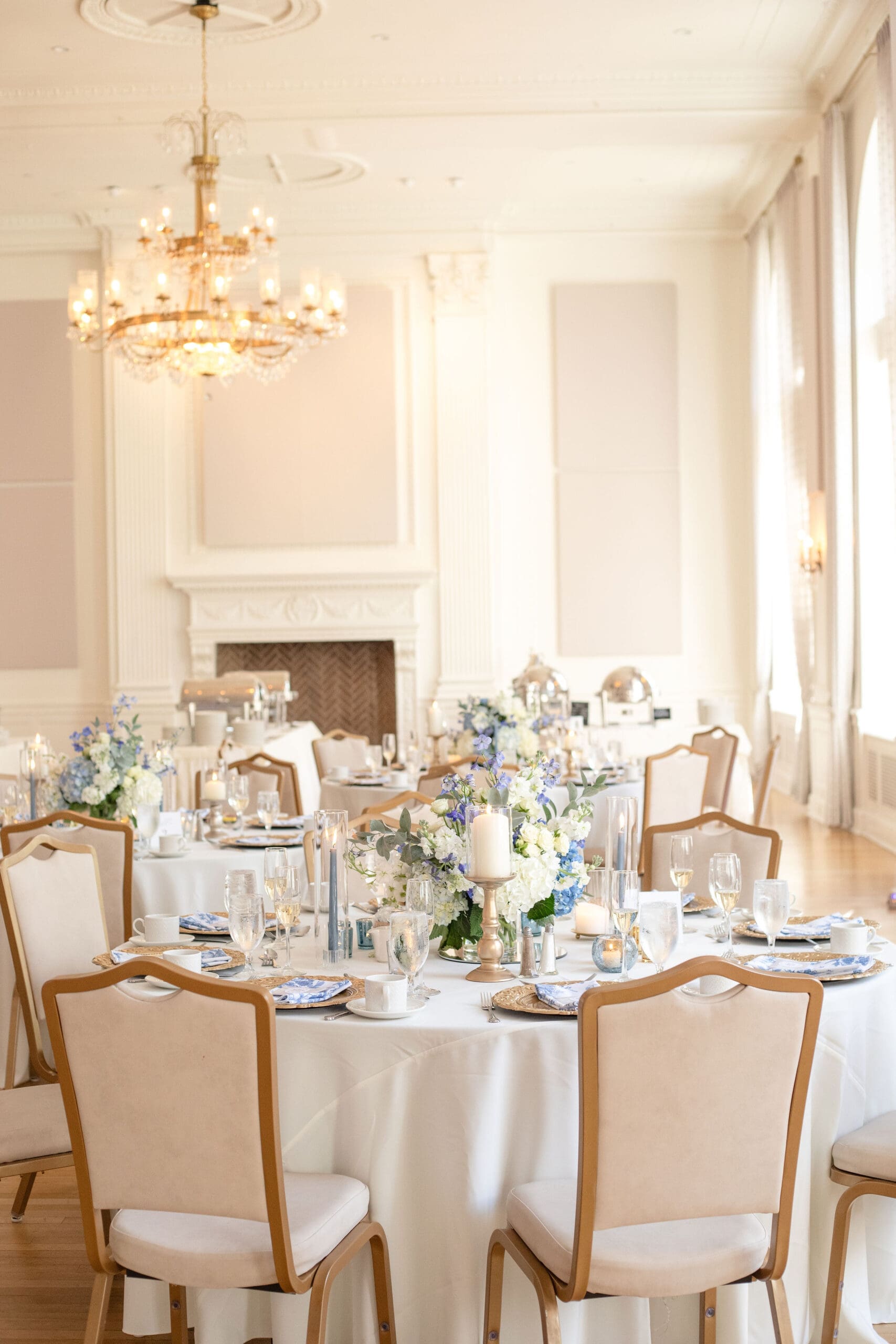 Wedding reception layout featuring beautiful hydrangea and candlestick tables capes