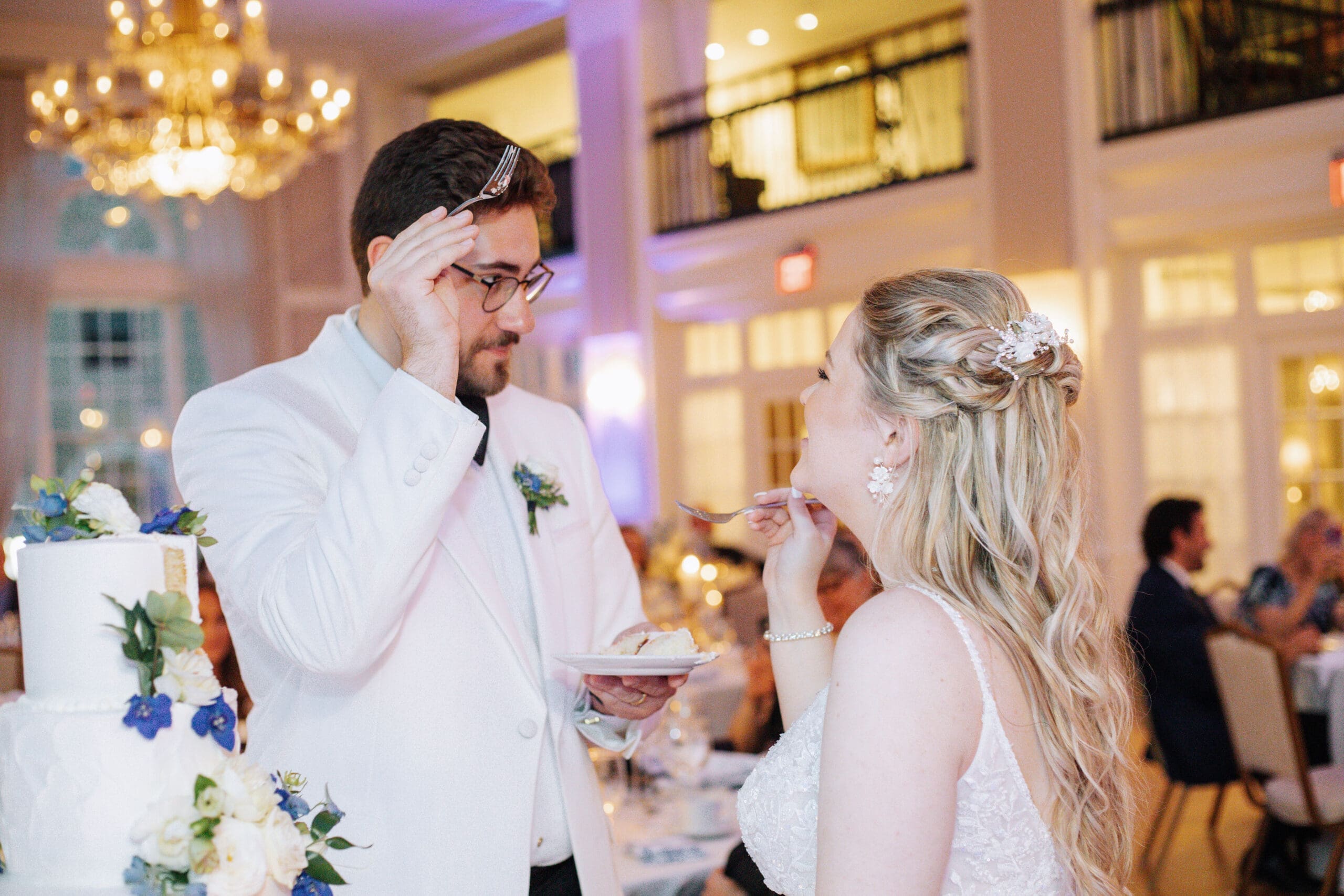 Bride and groom split their wedding cake during their wedding reception 